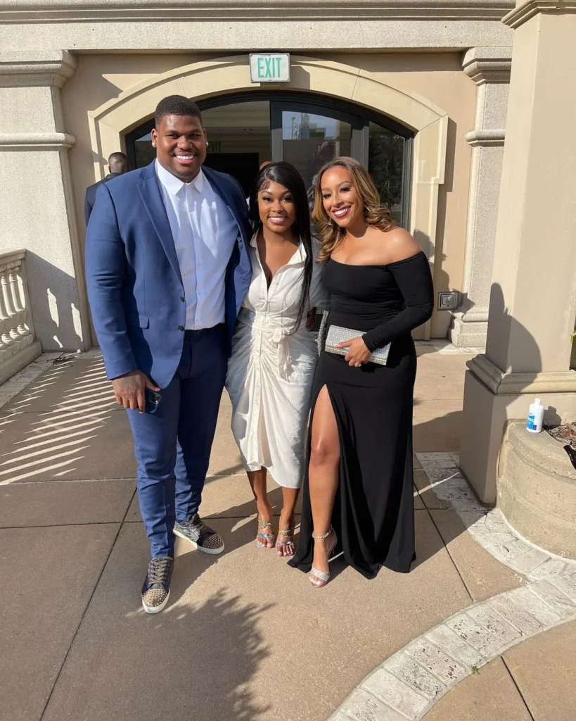 Nicole Lynn with Quinnen Williams and his wife