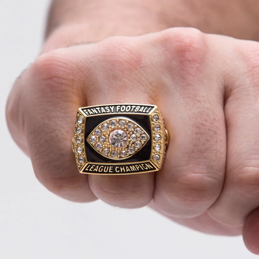 A fantasy football championship ring in a hand